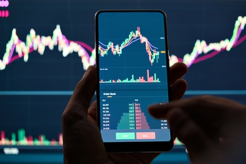 Crypto trader investor broker holding finger using cell phone