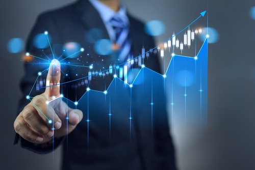Businessman draws increase arrow with candle stock graph