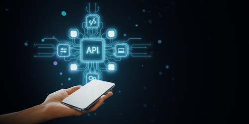 A hand holding a smartphone with holographic API icons